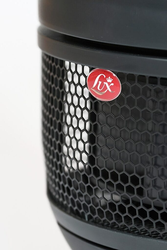 Aeroguard 360 PRO & Premium Close-up of an Aeroguard 360 PRO & Premium air purifier by Lux, featuring a hexagonal mesh grille and a red circular Lux logo with a crown on top. The white background is softly out of focus.