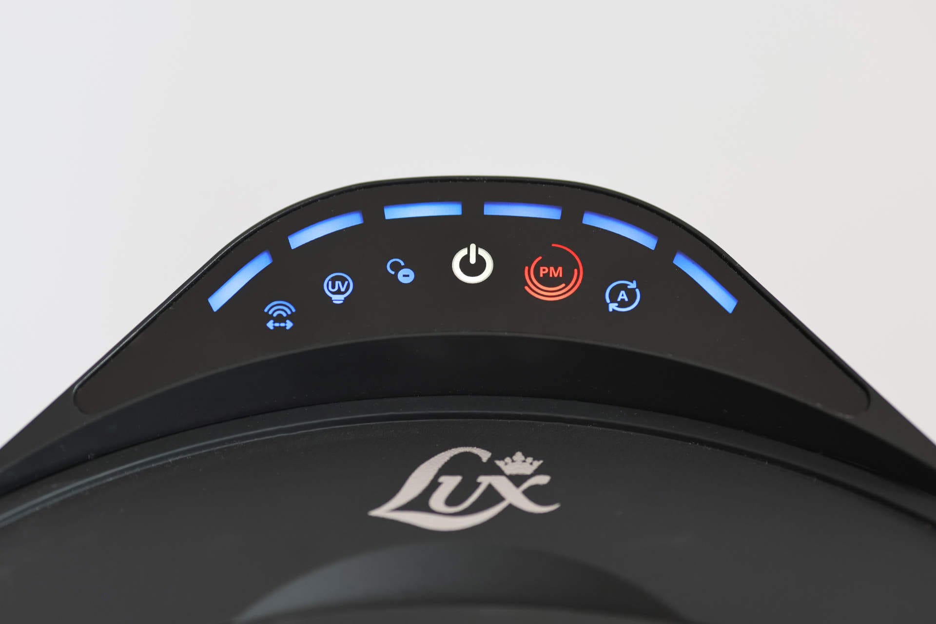 Aeroguard 360 PRO & Premium Close-up of a control panel with blue-lit icons and a red PM indicator, including power, UV, and Wi-Fi symbols, on a device labelled “Lux”.